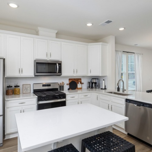 a kitchen with white cabinets