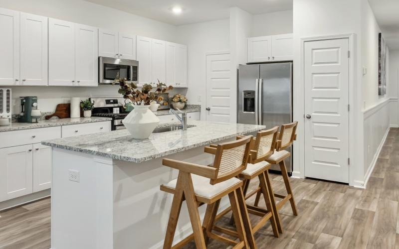 a kitchen with white cabinets